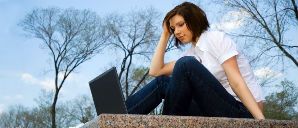 student sitting outside with laptop